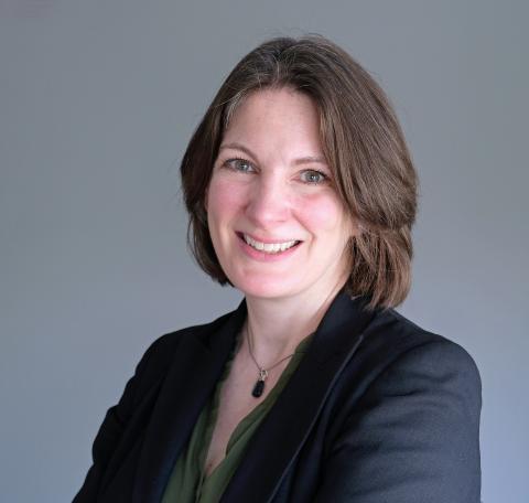 A white woman with brown hair in a black jacket