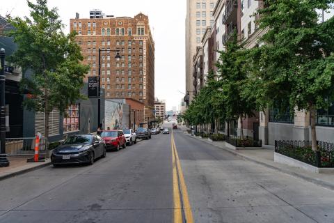 Empty downtown Kansas Citystreet in the daytime with cars parked on one side