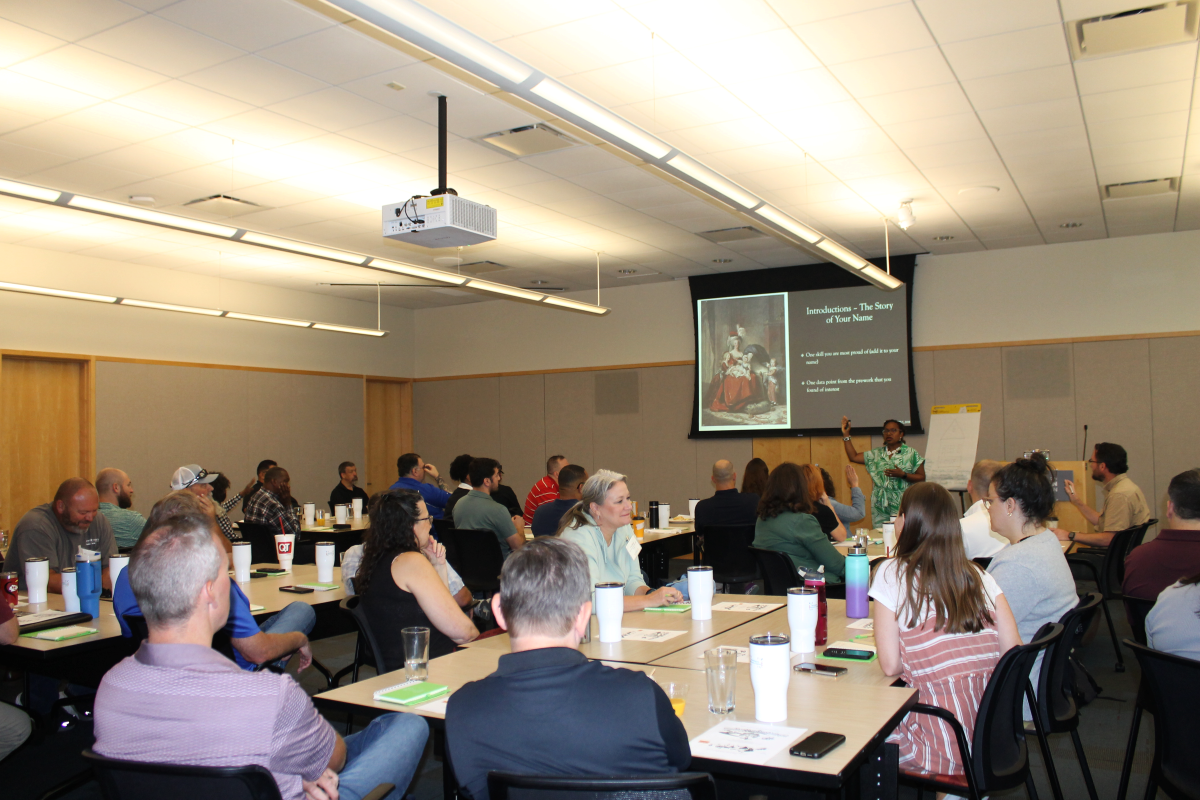 Audience of elected officials looking at a panel for a World Cup briefing